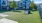 a large green lawn in front of a row of houses